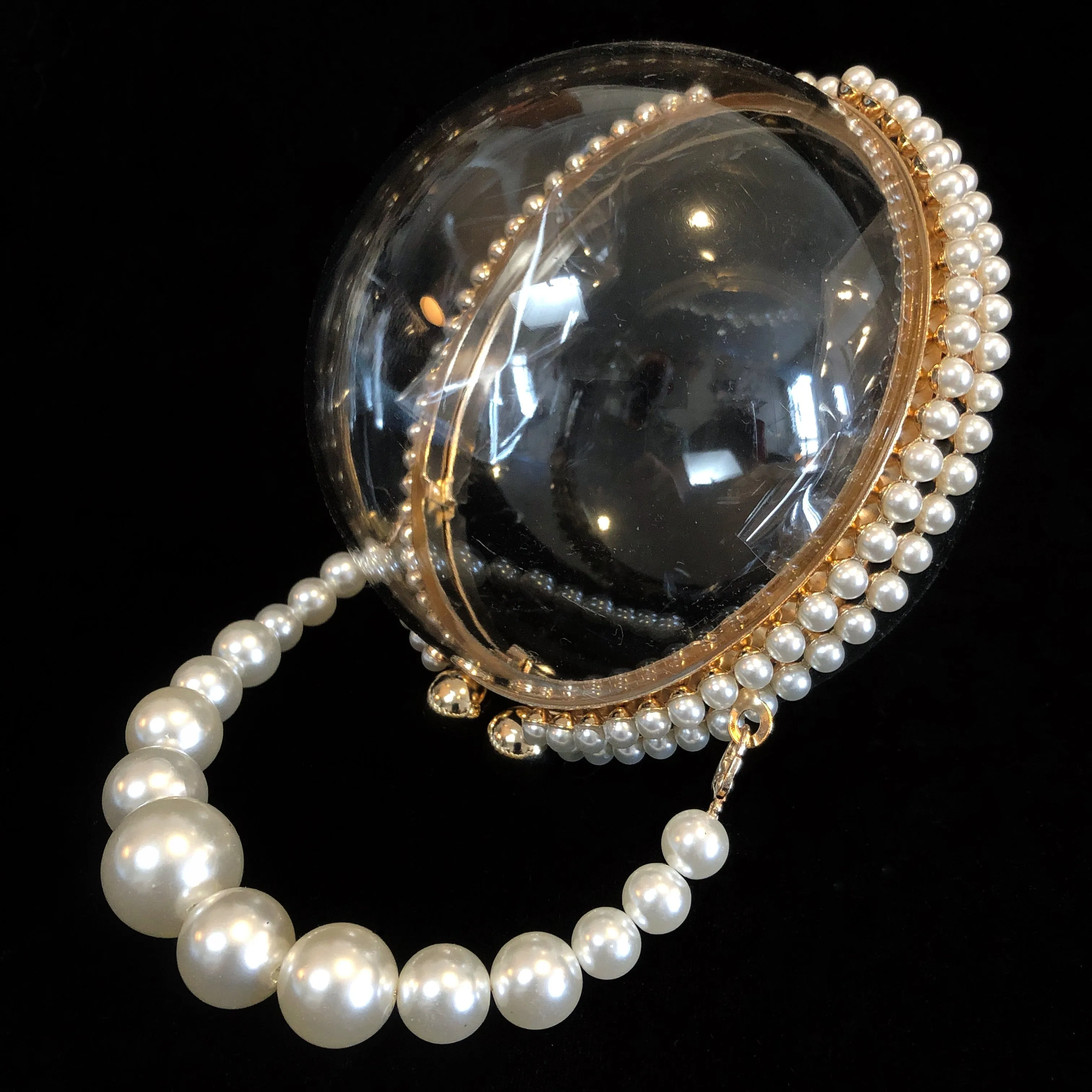 A PERSPEX SPHERICAL EVENING BAG WITH PEARLS